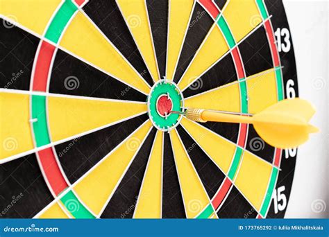 A Dart Board with an Arrow in Bullseye Close Up, Goals and Targetting ...