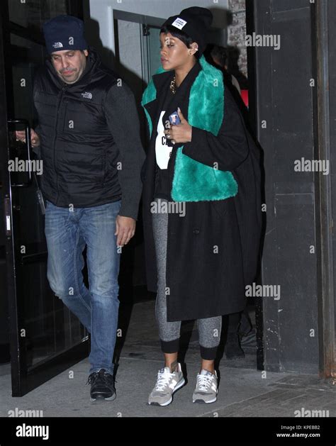 NEW YORK, NY - DECEMBER 13: Singer Rihanna rocks a Tupac Shakur Iphone ...