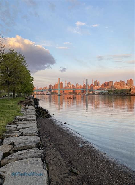 Randall’s Island beach on the Harlem River fronts the New York skyline & Wards Island Bridge at ...