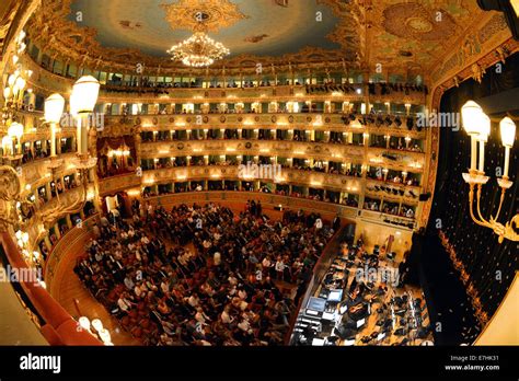 Visitors sit in the auditorium of the opera house Teatro La Fenice ...