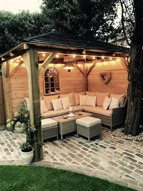 Homemade wooden gazebo, cobbles, garden lights, outdoor sofa, outdoor seating, alfresco lounging ...