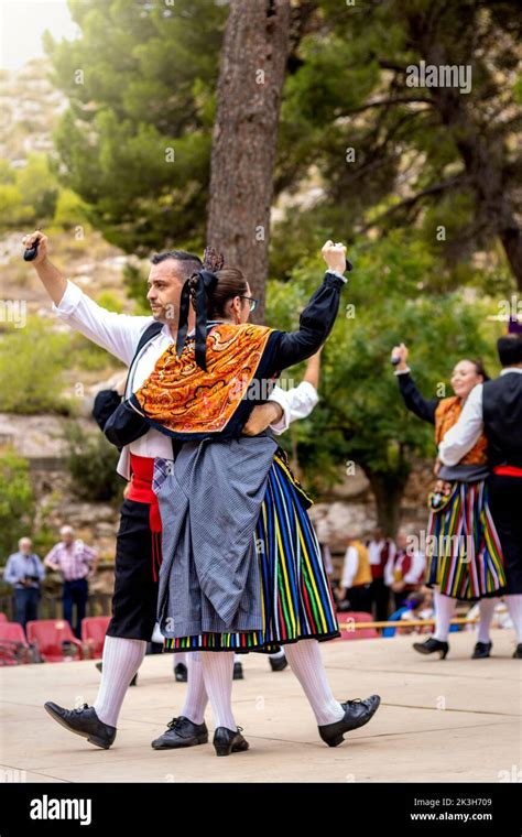 Spanish people wearing traditional clothes dancing Stock Photo - Alamy