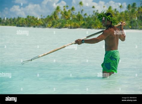 A tahitian fisherman is fishing with a trident harpoon Stock Photo - Alamy