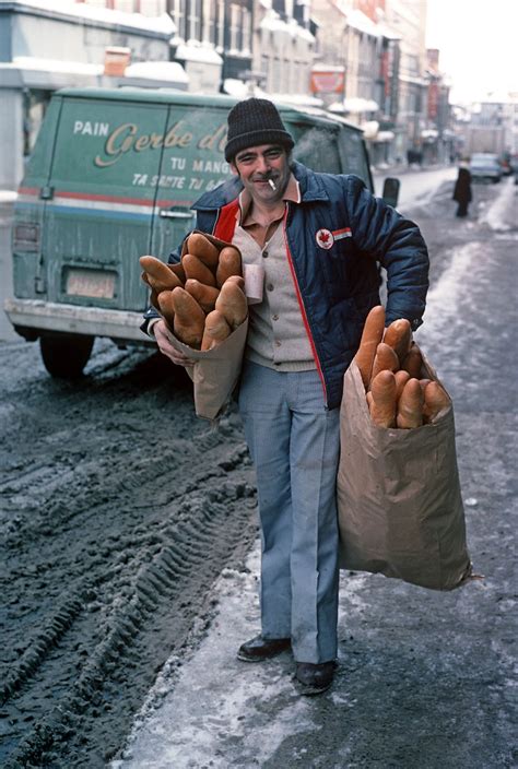 A bread delivery man with bags filled with baguettes on a snowy street in Quebec in 1977 : r ...