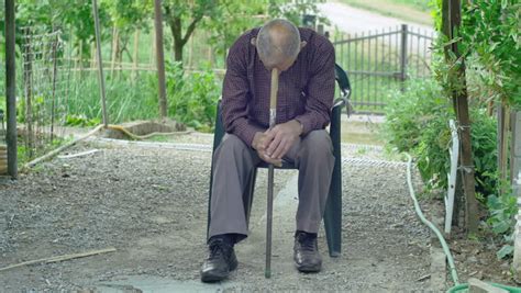 old man sleeping outdoor: very tired elderly in countryside, 4k footage ...