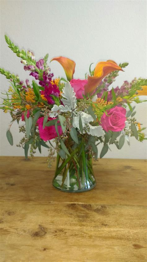 Colorful vase arrangement using Mango Callas, Pink Floyd roses, Snapdragons, Dusty Miller ...