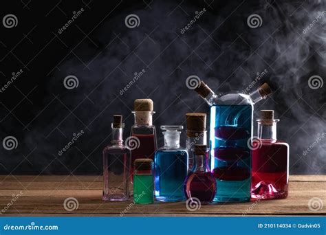 Colorful Magic Potion Bottles on Wooden Table. Medieval Alchemist ...