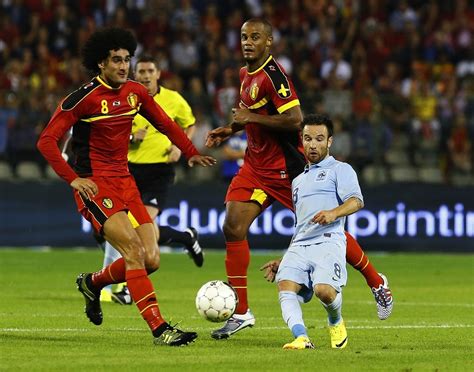 France's Mathieu Valbuena gets dwarfed by Marouane Fellaini and Vincent ...