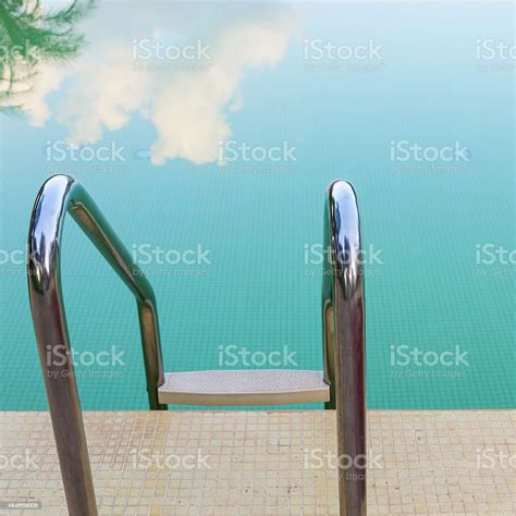 Steel Stair Of Green Swimming Pool With Sky Reflection Stock Photo - Download Image Now - iStock