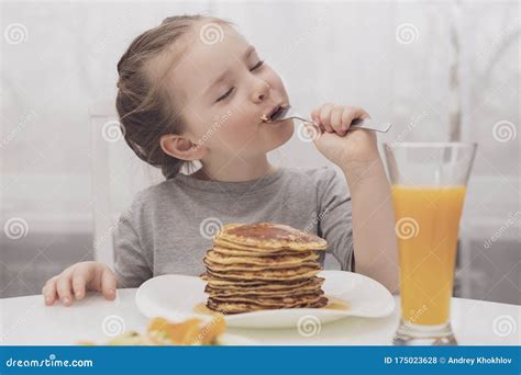 Little Girl Eating Pancakes and Eyes Close Stock Photo - Image of girl ...