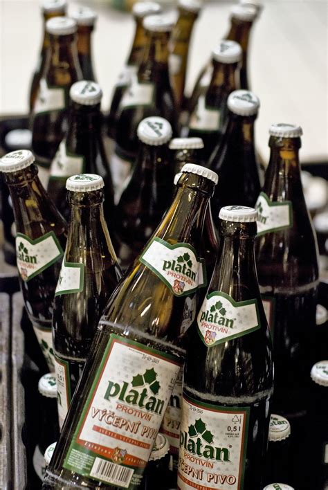 bottles of beer are lined up in a bin