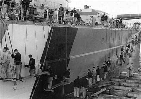 Crew of 15 in battleship Bismarck painting ship; early 1941. She was in this camouflage scheme ...