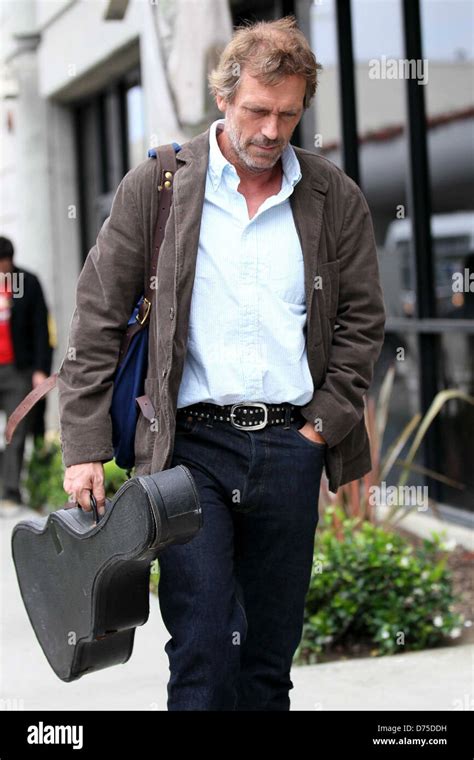 Hugh Laurie carrying his guitar as he arrives at LAX airport on a ...