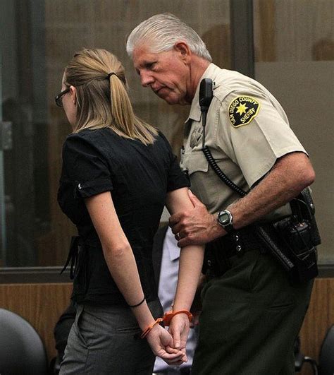 Woman in orange handcuffs behind back led by police officer. | Prison ...