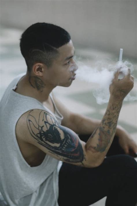 Man With Tattoo Smoking Cigarette · Free Stock Photo