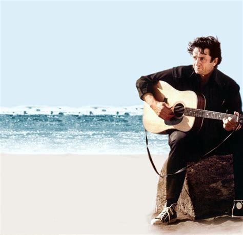 Johnny Cash, in black, at the beach, playing guitar, wearing some Chuck ...