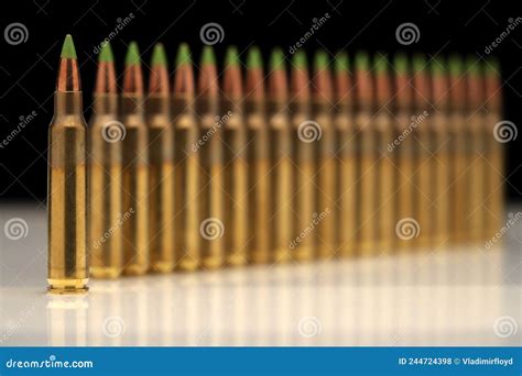 A Group of 5.56 Calibar, Green Tip Bullets Ordered into the Line on Black Background Stock Photo ...