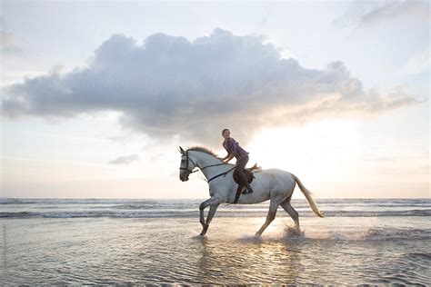 "Women Horse Riding On Beach At Sunset." by Stocksy Contributor "Hugh Sitton" - Stocksy