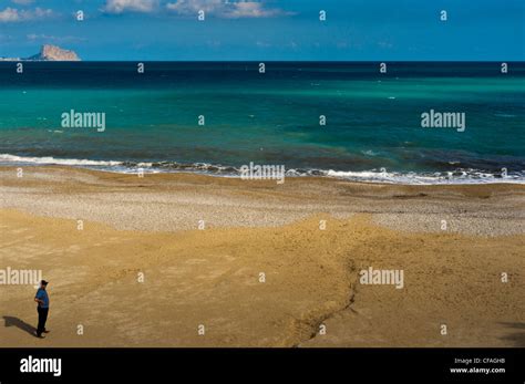 A man alone on a beach Stock Photo - Alamy