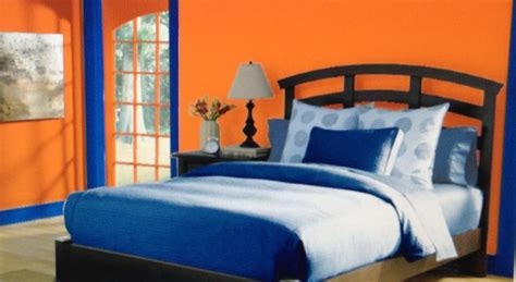 This is a complementary bedroom with a color scheme of bright orange, and different shades and ...