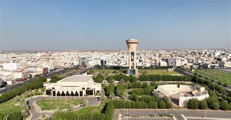 Tabuk Tower in the city of Tabuk, Saudi Arabia, trees and green plants ...