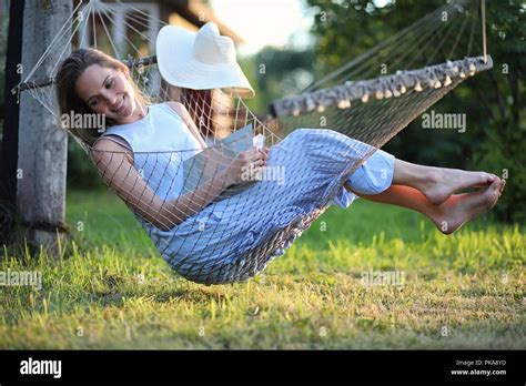 Beautiful young girl lying and reading a book Stock Photo - Alamy