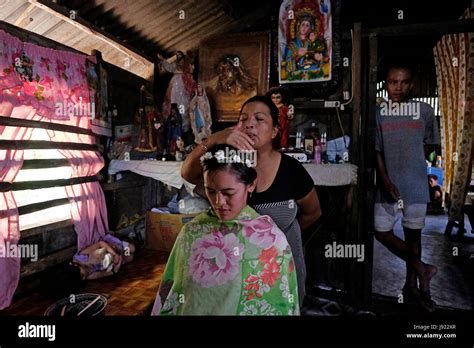 A Mananambal spiritual healer performs a healing ritual on a young Filipino woman in the island ...