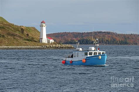 Fishing Boat and Lighthouse Photograph by John Malone