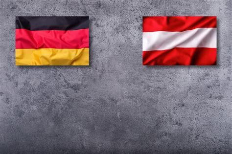 Premium Photo | Flags of the germany and austria on concrete background.