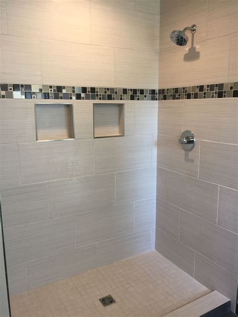 Custom Tiled Shower with Glass and Metal Mosaic Accent Strip