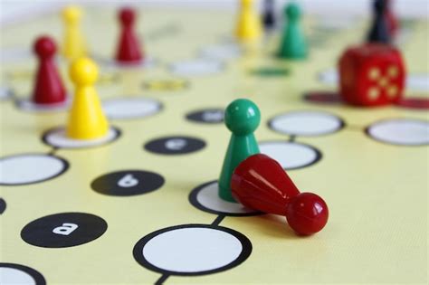 Premium Photo | Close-up of game pieces and dice on ludo