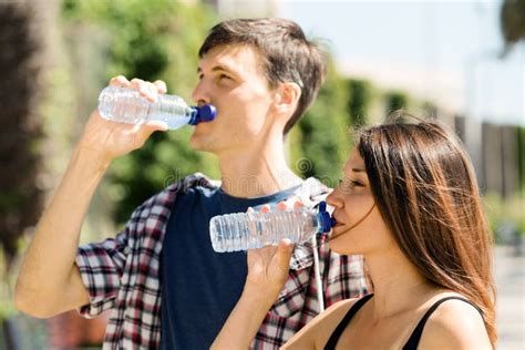 Couple Drinking Water from Plastic Bottles Stock Image - Image of ordinary, pleasure: 41573051