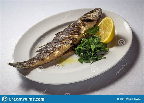 Sea Bass with Lemon and Herbs Stock Photo - Image of dinner, table: 137118126