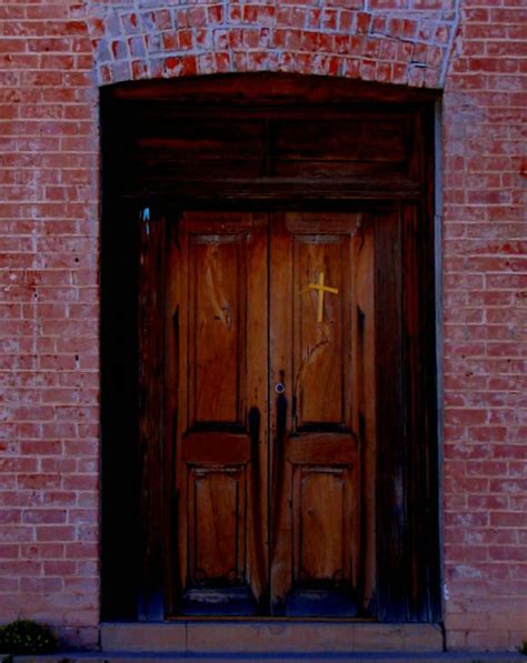 File:Wooden door in brick building with small cross.jpg - Wikimedia Commons