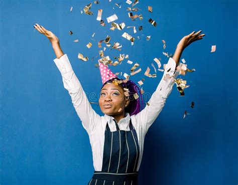 Beautiful Young Black Woman Celebrating Birthday or New Year and Chrismas Party while Blowing ...