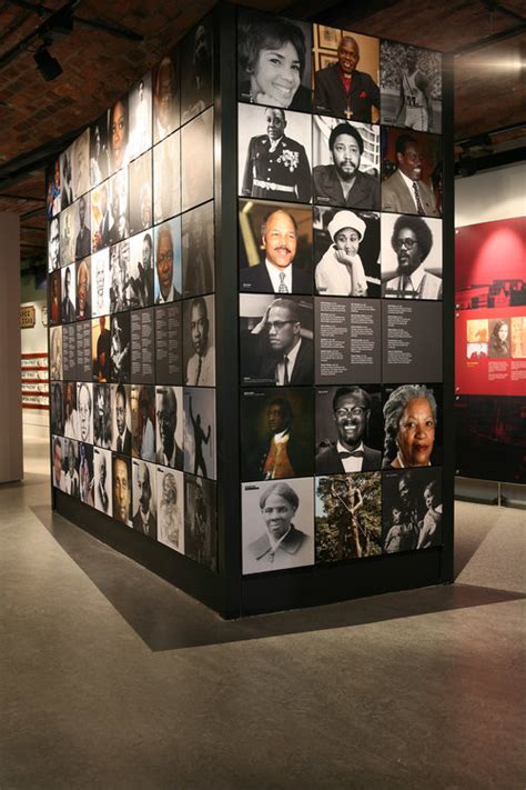 an exhibit with many black and white pictures on it's walls, including portraits of people