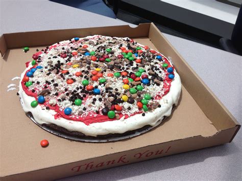 a birthday cake in a box with candy and sprinkles on the top