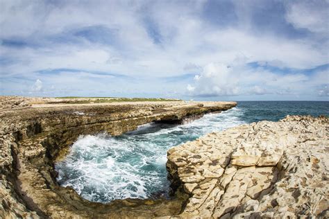 Watching the waves at Devil's Bridge in Antigua Photograph by John ...