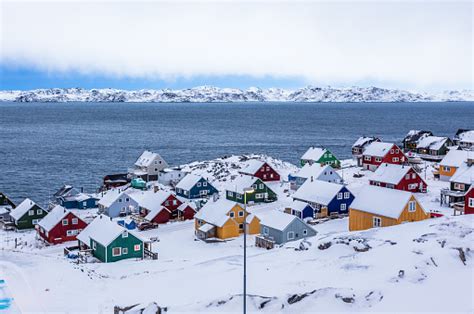 Colorful Inuit Houses Among Rocks And Snow At The Fjord In A Suburb Of ...