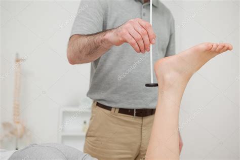 Doctor checking the reflexes of a patient — Stock Photo ...