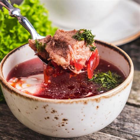 Premium Photo | Traditional borsch with meat and sour cream closeup