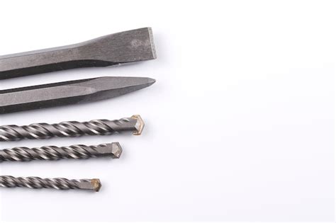 Premium Photo | Metal chisel and drill bits on concrete for perforator isolated on white background