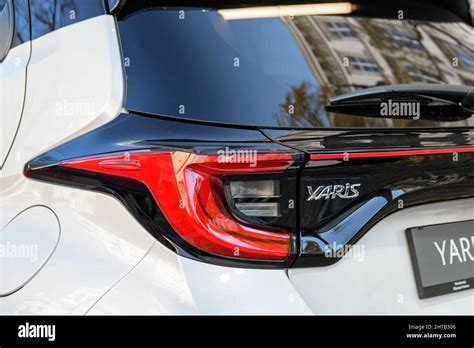 Rear end and tail lights of new white Toyota Yaris hybrid car Stock Photo - Alamy