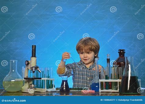 Happy Smiling Pupil Drawing at the Desk. Biology Experiments with Microscope Stock Image - Image ...