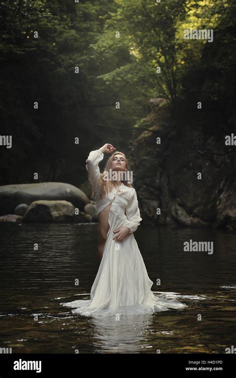 Beautiful woman posing in dreamy mountain stream. Fantasy and surreal ...