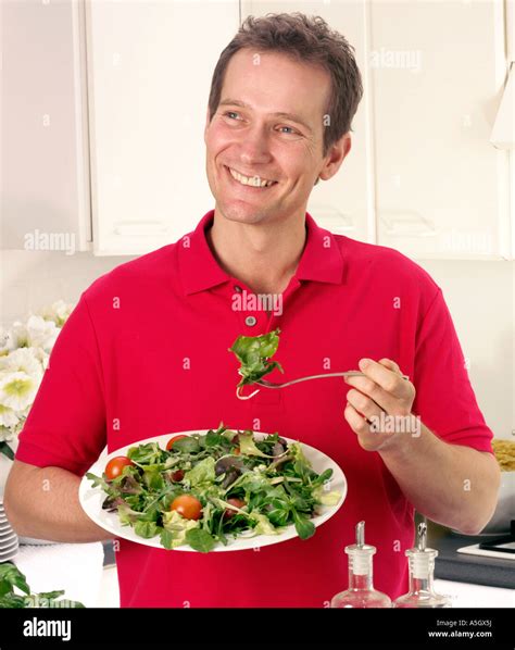 MAN EATING MIXED SALAD Stock Photo - Alamy