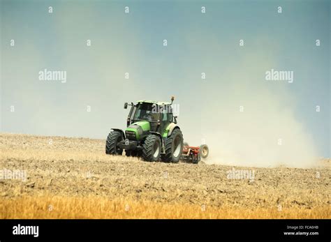 Tractor plowing field Stock Photo - Alamy