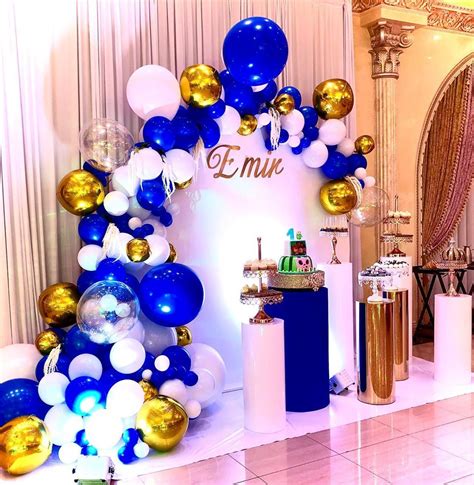 💎 Our white acrylic circle wall with a royal blue, white, and gold organic balloon garl ...