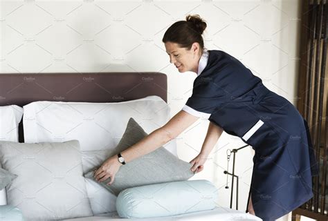 Housekeeper cleaning a hotel room | Stock Photos ~ Creative Market