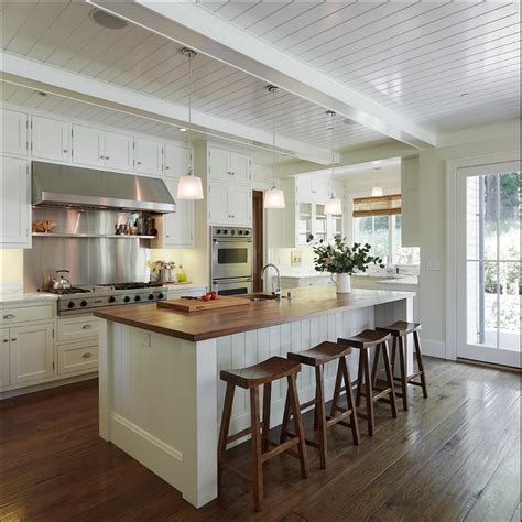 White cabinets, butcher block island, saddle stools, plank ceiling ...